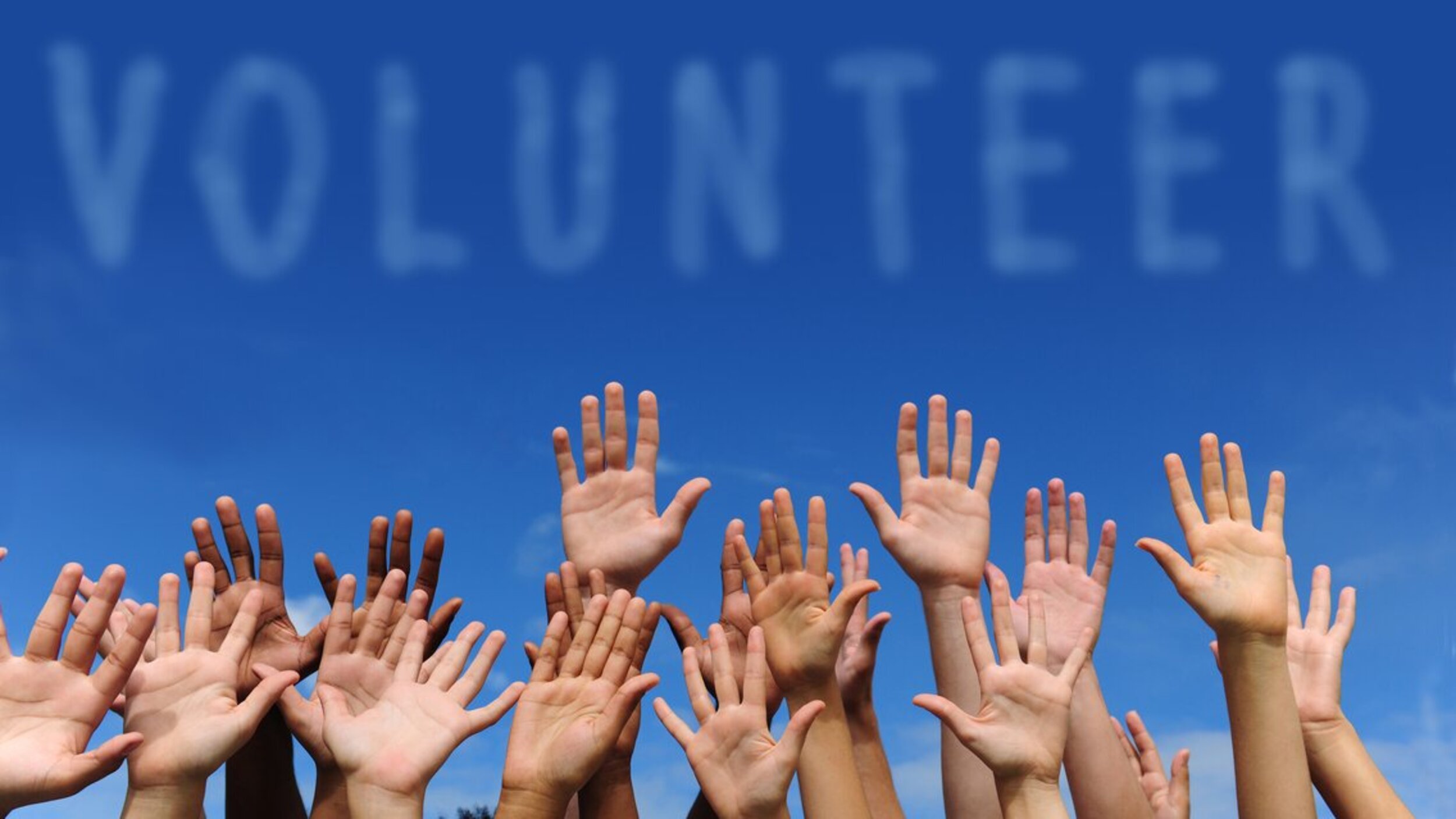 volunteer group raising hands volunteer group raising hands